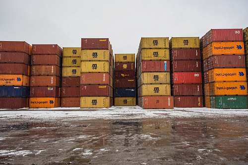 montreal assorted-colored cargo container lot during daytime transportation